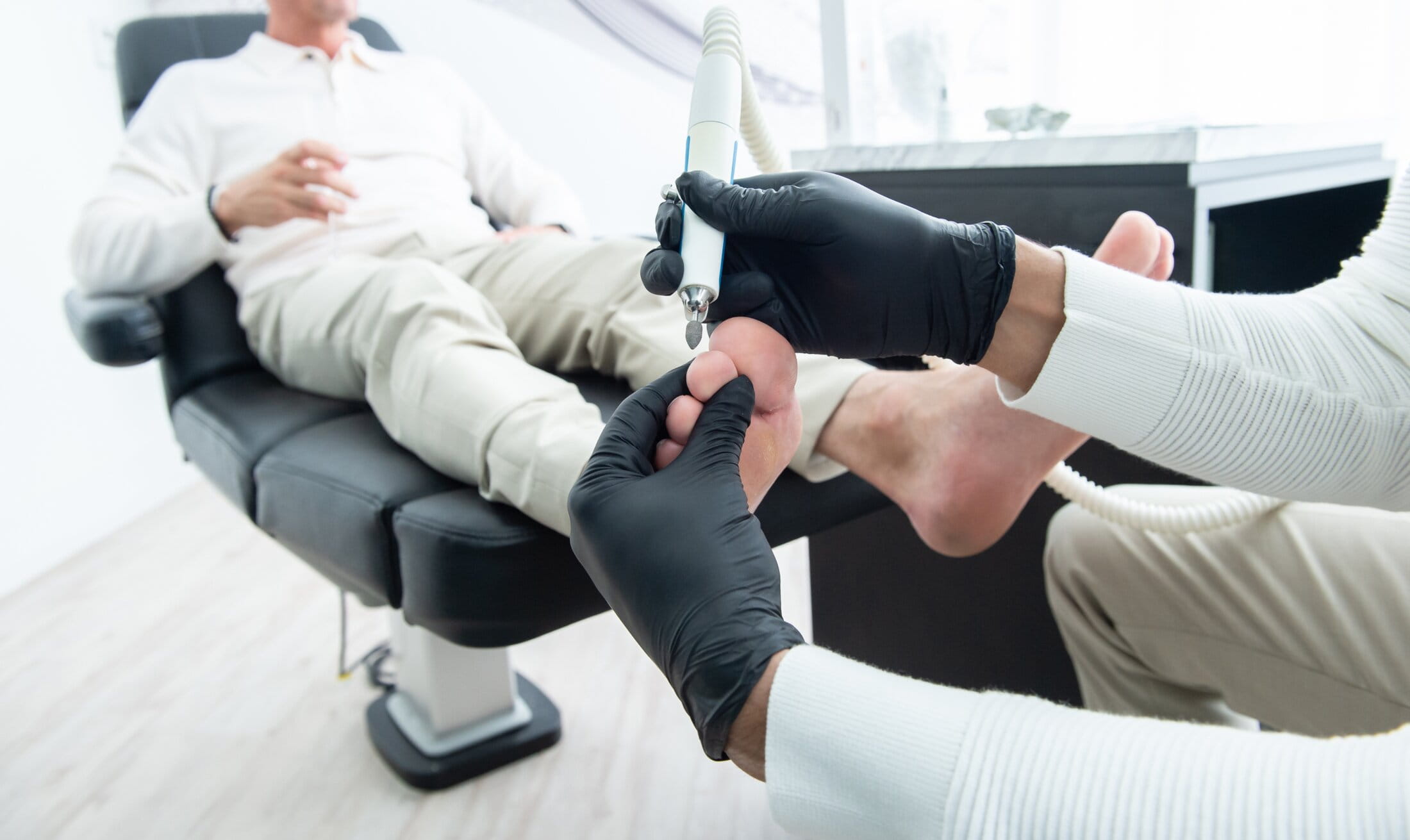Mississauga chiropodist using a podiatry drill on a patient's foot